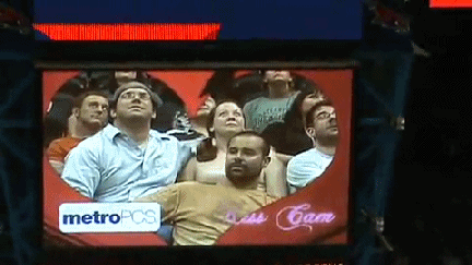 Male spills beer on another guy while on the kiss cam