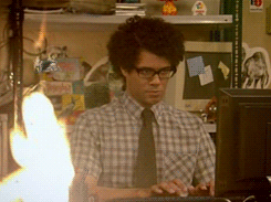 the it crowd moss looks at a fire while working