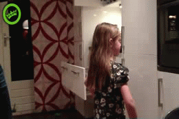 gif of a dad using a vacuum to do daughters pony tail