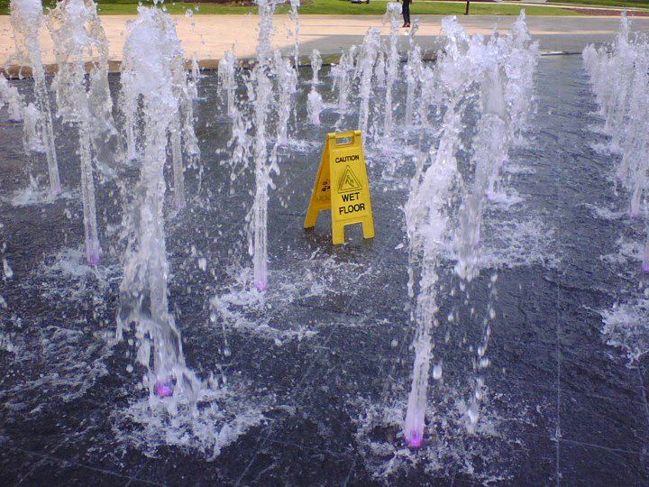 floor with water fountain saying caution wet floor