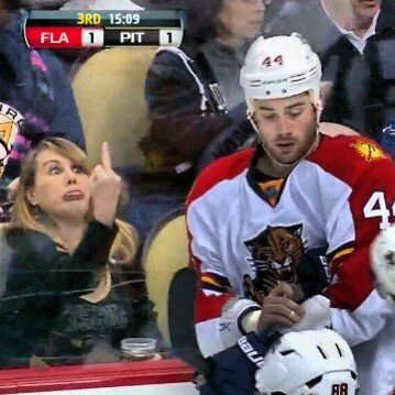woman flips a hockey player the bird