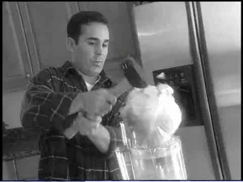 Guy hammers a cabbage into his blender.