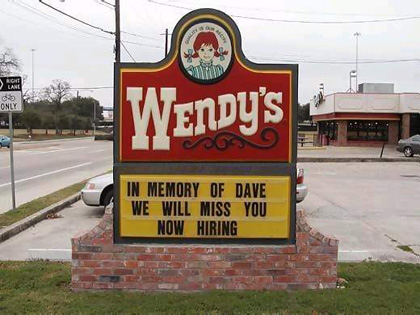 Wendy's restaurant displays a sign that pays respect to Dave followed immediately by a now hiring.