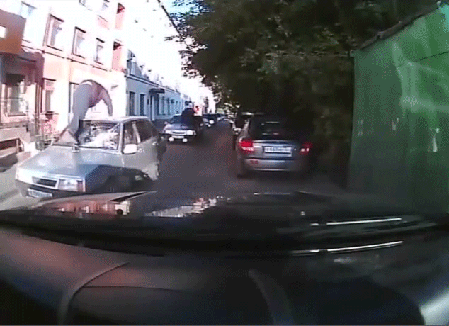 A loop of cars drives by each with a man top kicking the windshield in. This happens in Russia.