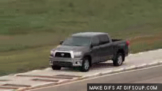 A truck moves down a bumpy path and its rear end moves from side to side in a twerk-like manner.